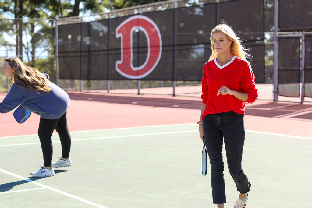 Two women on a tennis court.