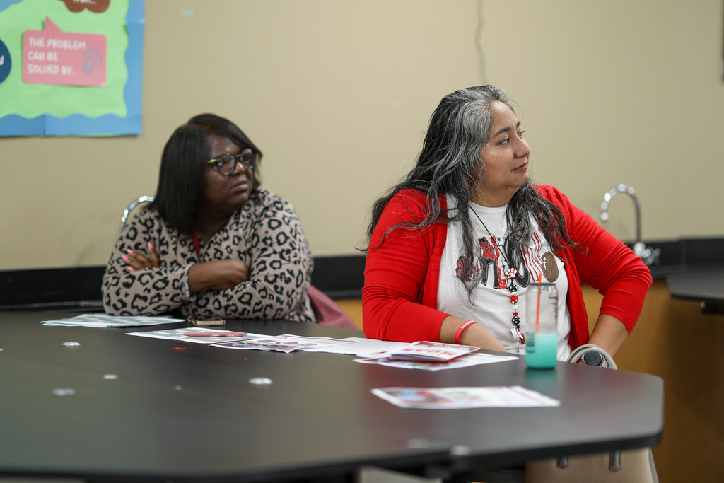 Two educators listening to a speaker.
