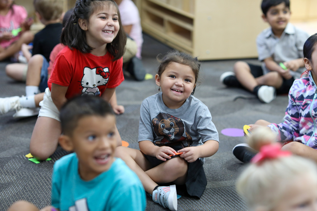 students smile in a classroom.