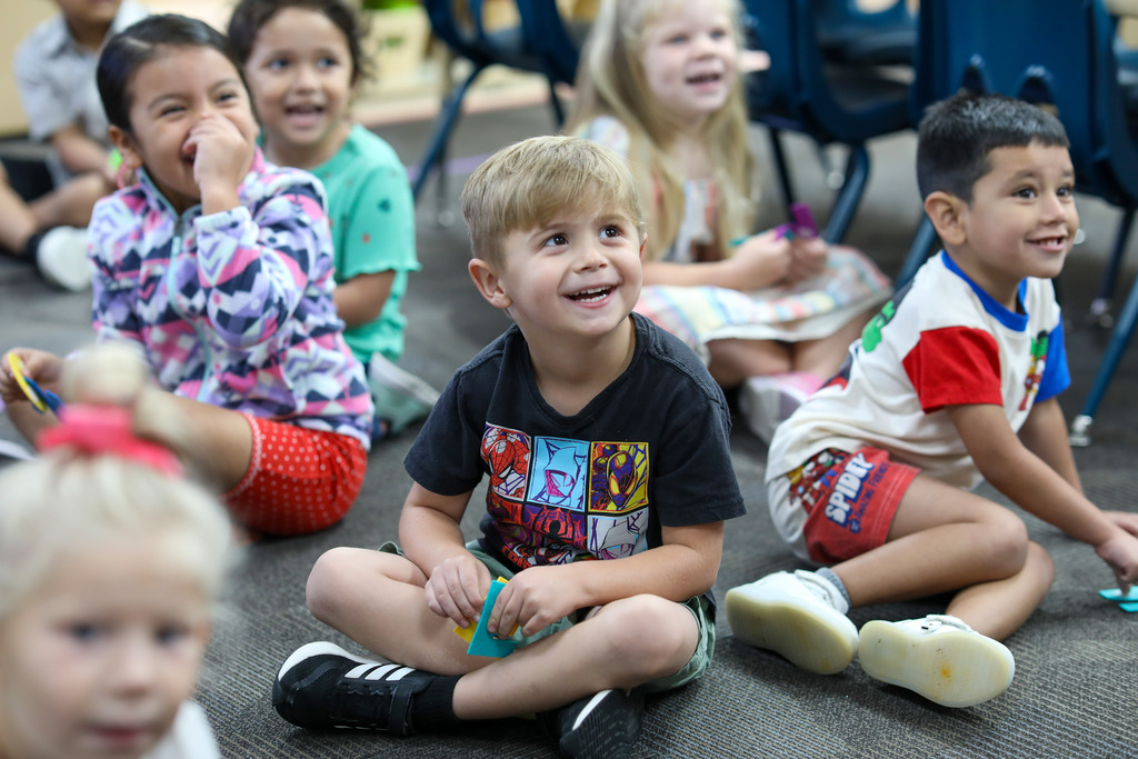 students smile in a classroom.