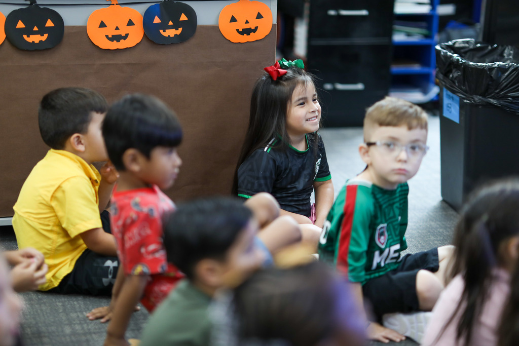 Students listen happily to a story.