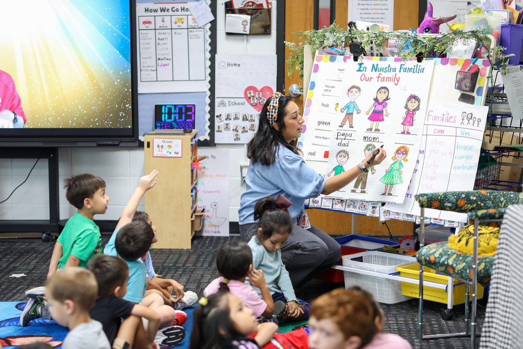 A teacher writes names on a board.
