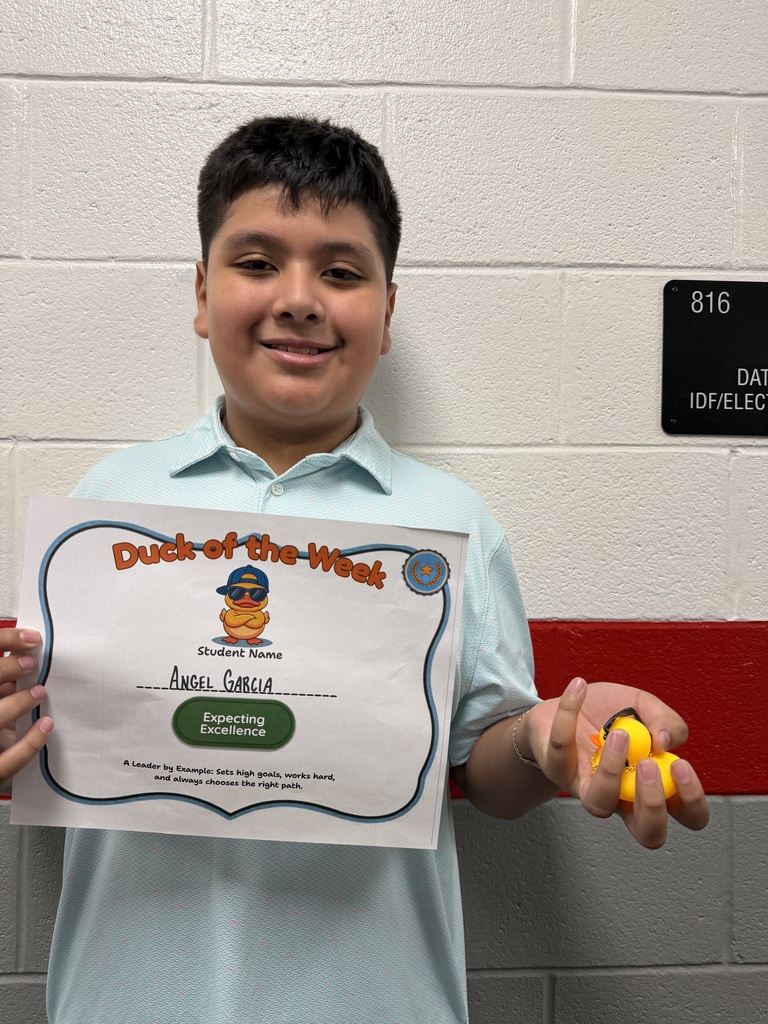 Angel Garcia holds a Duck of the Week certificate and a duck after being recognized for Expecting Excellence.