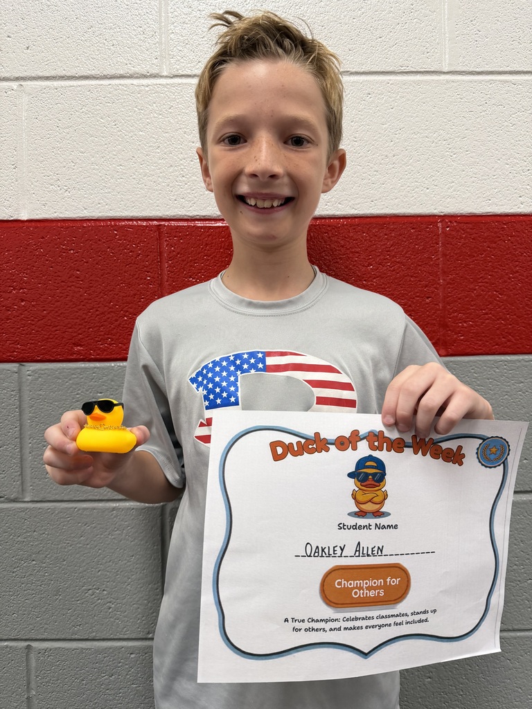 Oakley Allen holds a Duck of the Week certificate and a duck after being recognized for Being a Champion for Others.