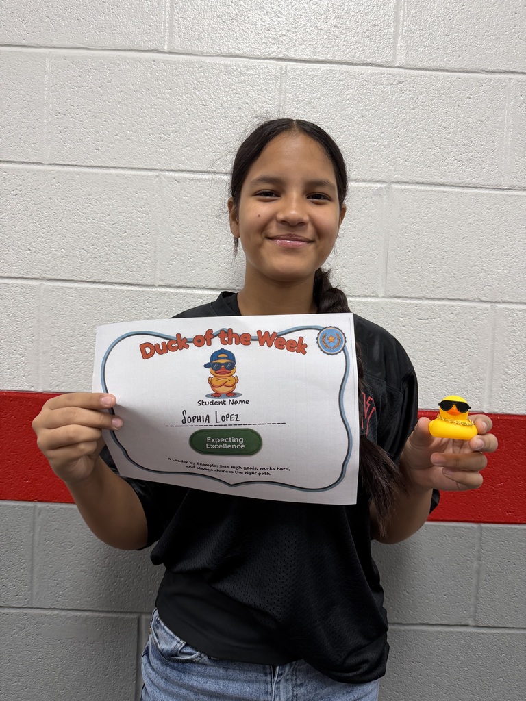 Sophia Lopez holds a Duck of the Week certificate and a duck after being recognized for Expecting Excellence.