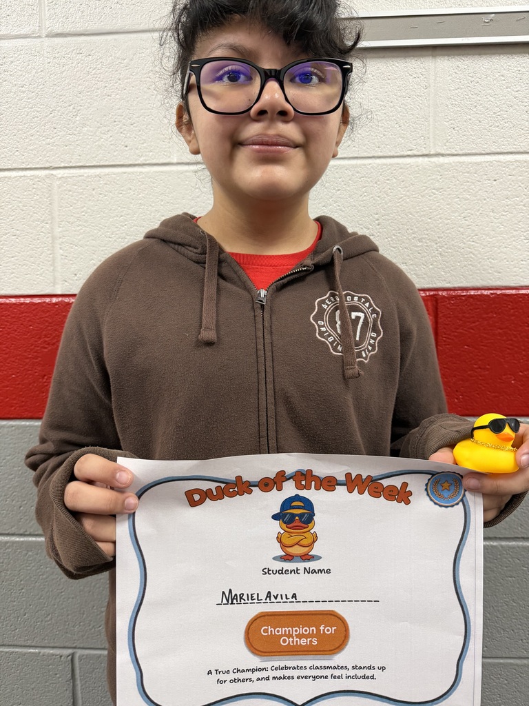 Mariel Avila holds a Duck of the Week certificate and a duck after being recognized for Being a Champion for Others.