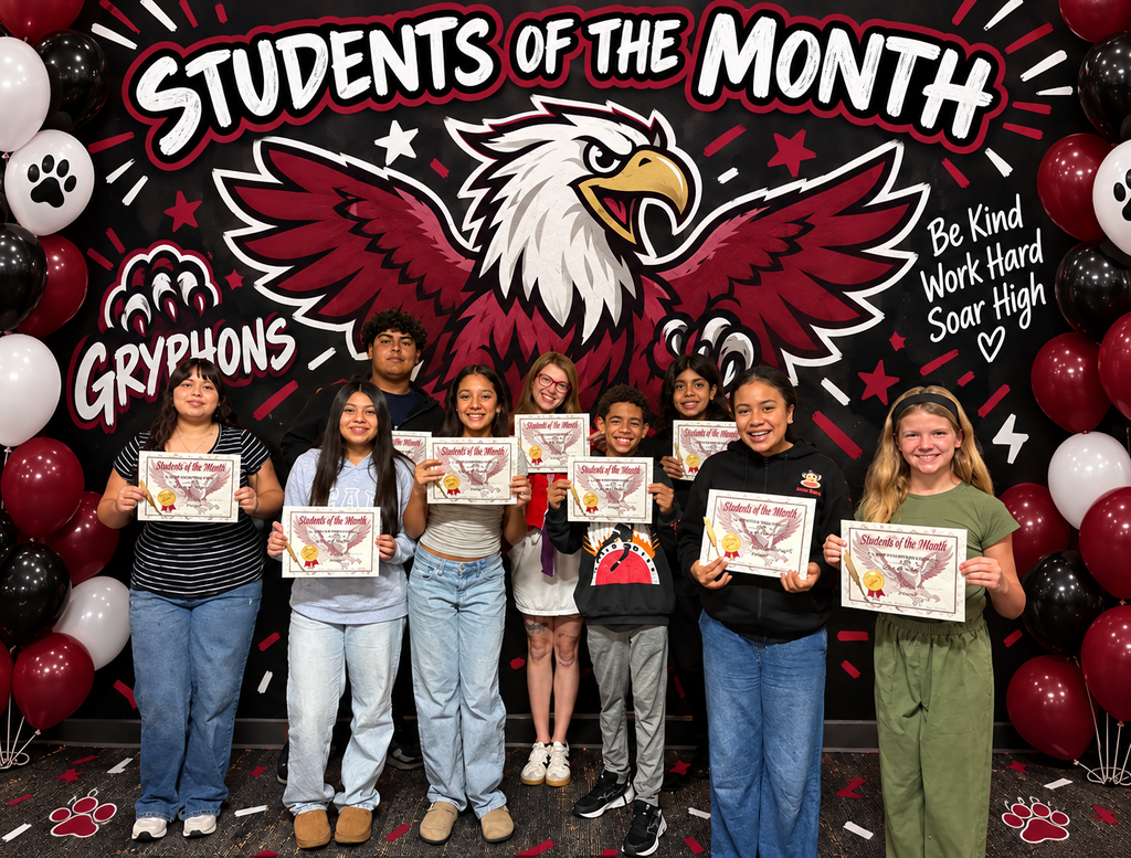 A group of 800 Gryphons Students of the Month and Teacher of the Month Malorie Noles smile while holding their certificates. The graphic features a Gryphons-themed background and the quote, “Be kind, work hard, soar high.”