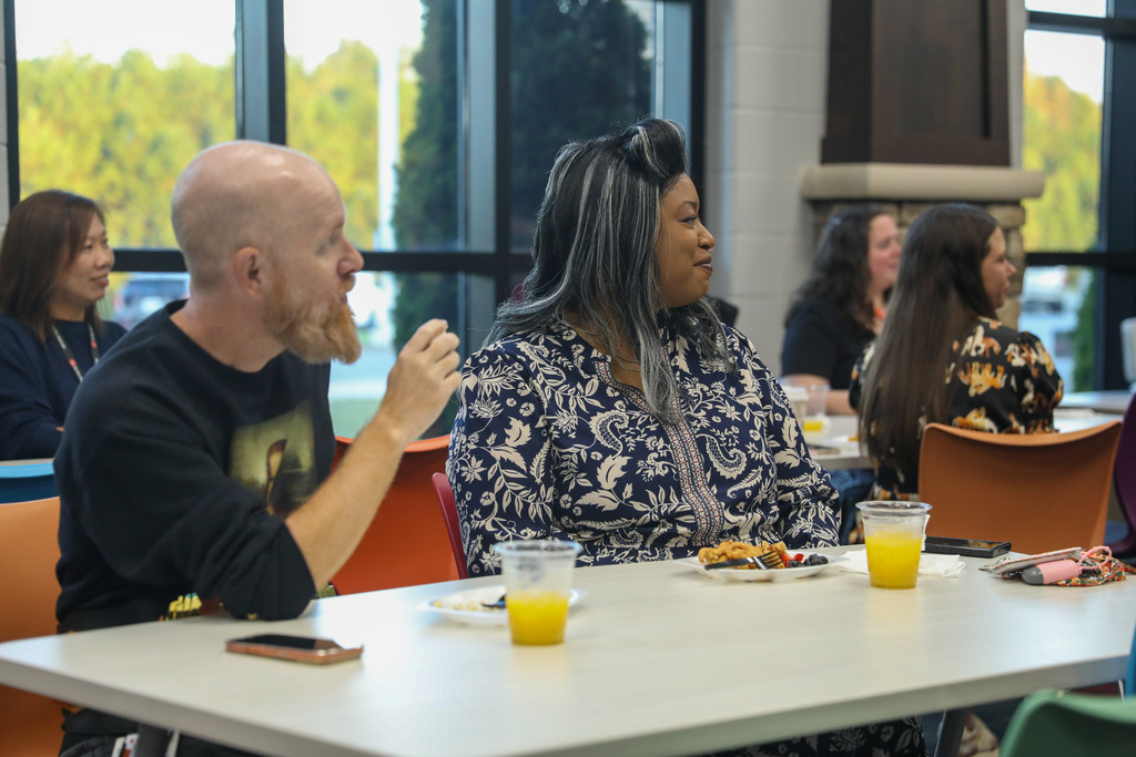 Staff members sitting at a table.