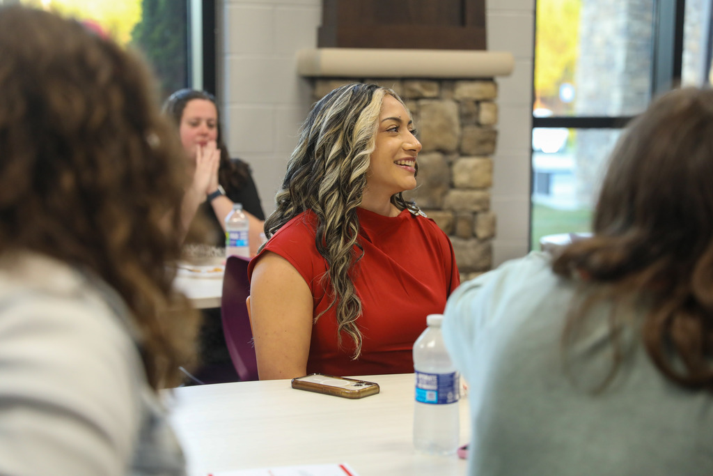 A staff member sitting at a table.