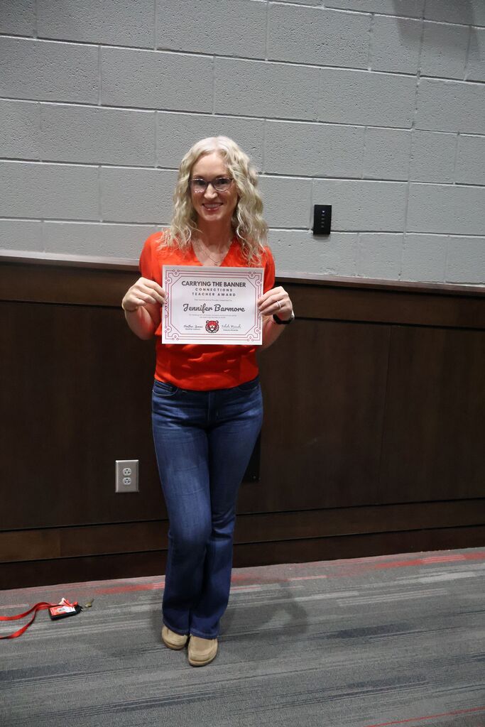 HCMS Teacher of the Quarter holding their award certificate.