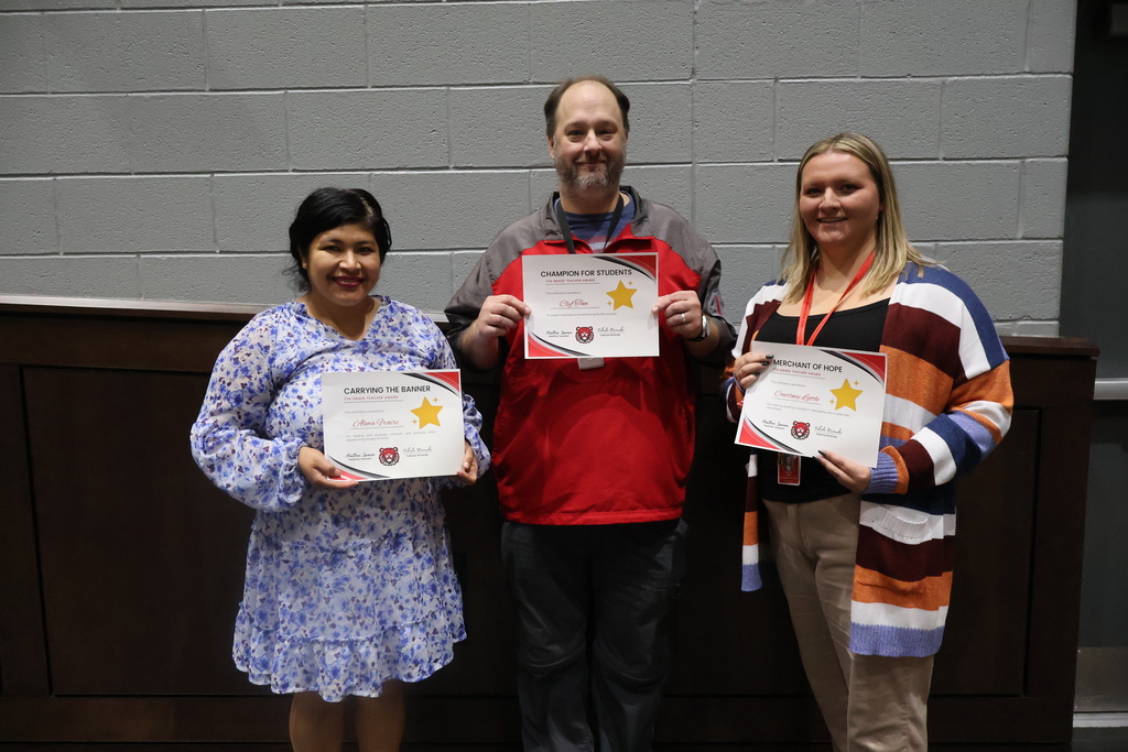 Three HCMS Teachers of the Quarter holding their award certificates.