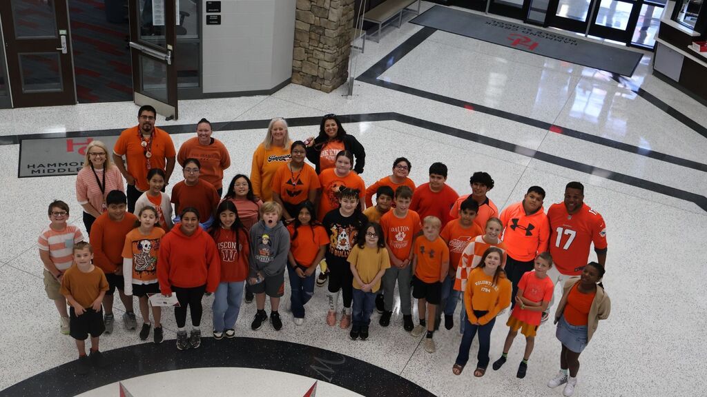Group photo of HCMS sixth-grade students and teachers wearing orange in recognition of Unity Day.