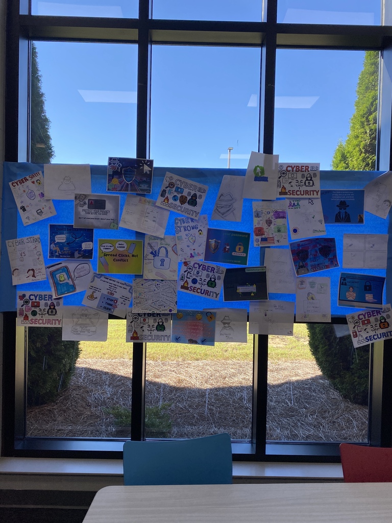 Student-created posters highlight the importance of online safety and kindness.