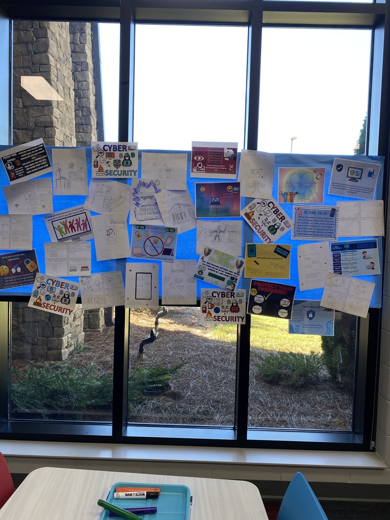 Student-created posters highlight the importance of online safety and kindness.