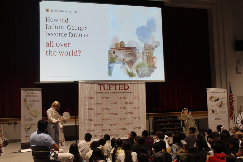 author Rachel Smalley presents in auditorium to students 