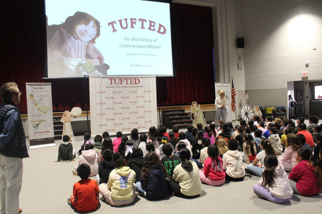author Rachel Smalley presents in auditorium to students 