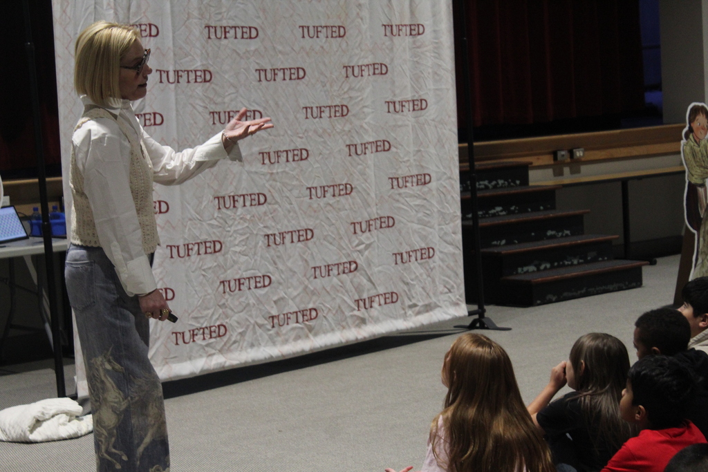 author Rachel Smalley presents in auditorium to students 