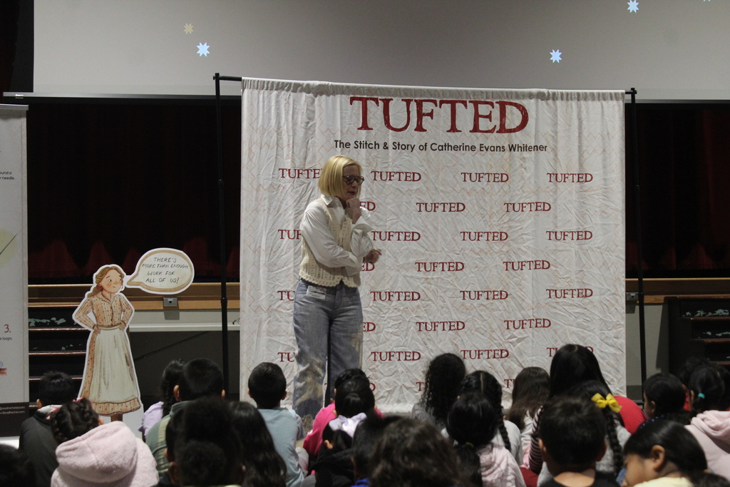 author Rachel Smalley presents in auditorium to students 