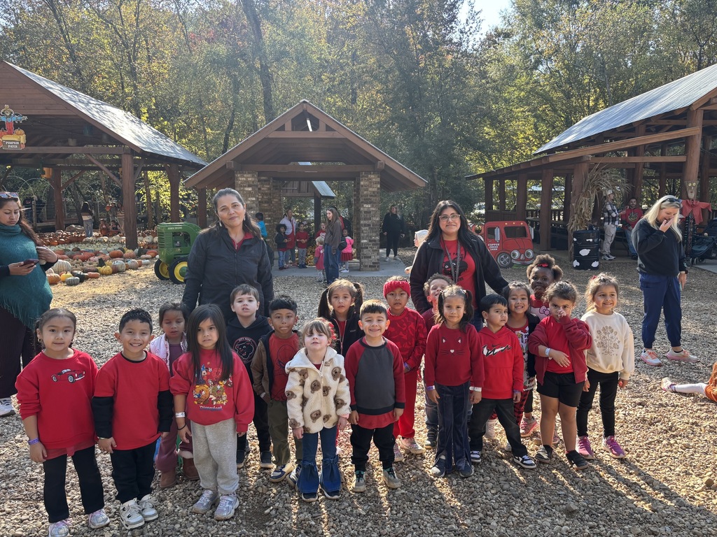 PreK students and their teachers posing for a photo at the pumpkin farm