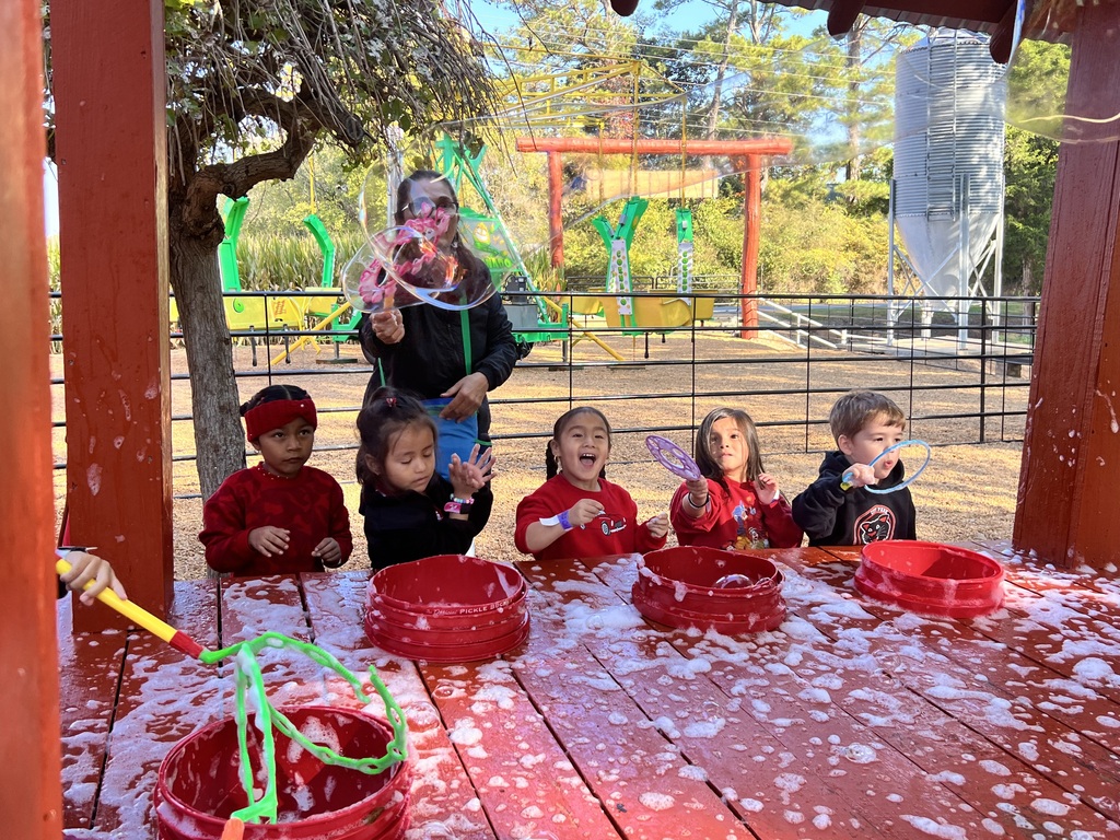 Prek students enjoying a bubble station at the pumpkin farm