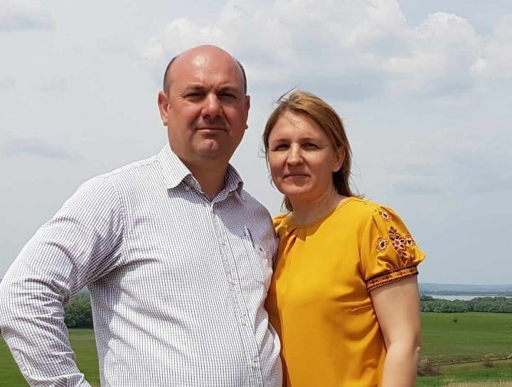 a man and a woman looking at the camera