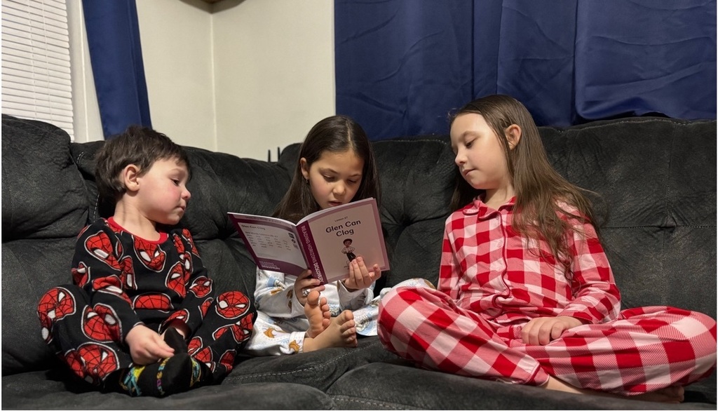 Three students reading in pajamas
