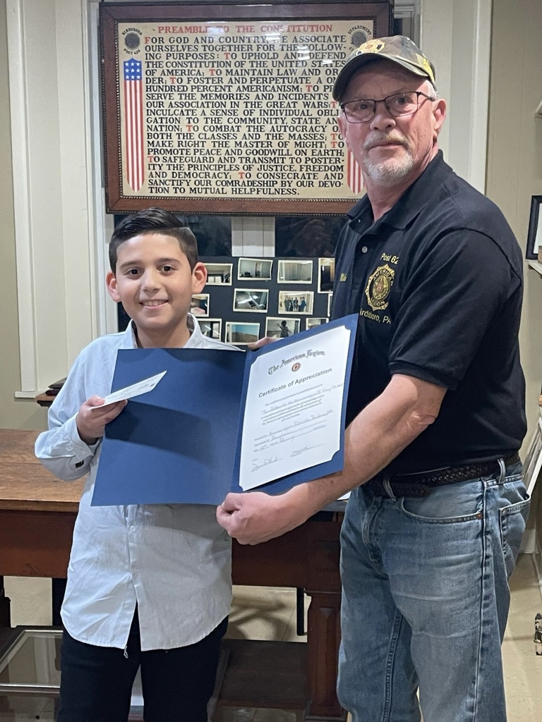 Juan receiving certificate and award for essay contest