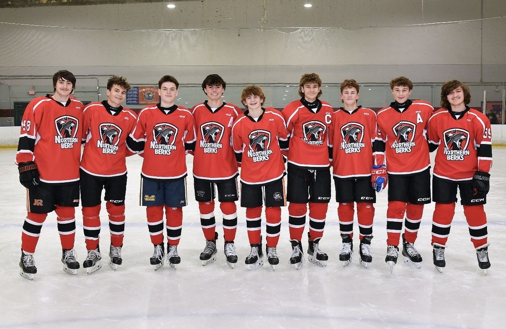 Picture of the nine Daniel Boone ice hockey players on the ice wearing their Northern Berks uniforms.