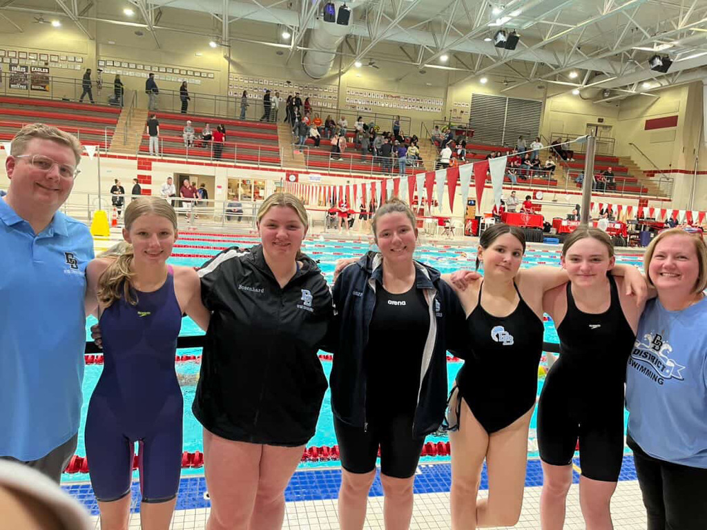 DB Swim girls swim team with their coaches at District Championships
