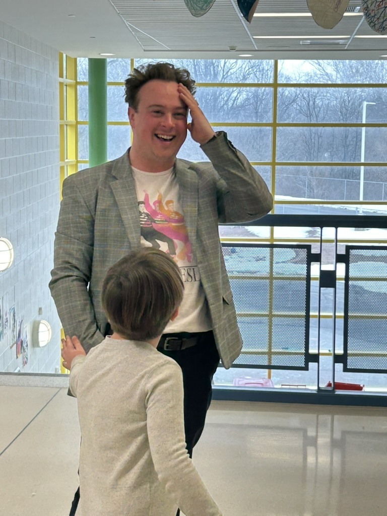 Mr. Steinman with his hand on his head, laughing.