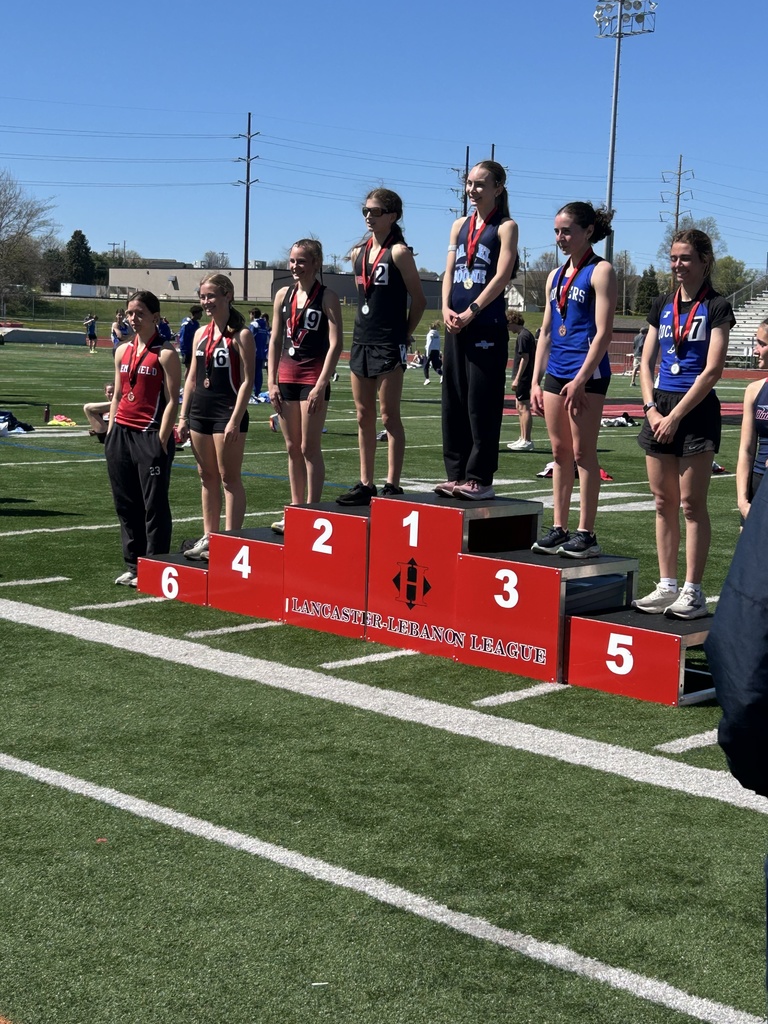 Photo is a group of medal winners on the podium outside on a football field.  Red podium shows 1-6th place winners at the Lancaster-Lebanon League. 