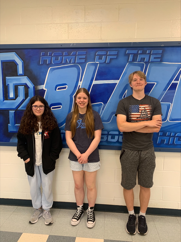 Picture of three high school students standing in front of a Home of the Blazers painted sign.