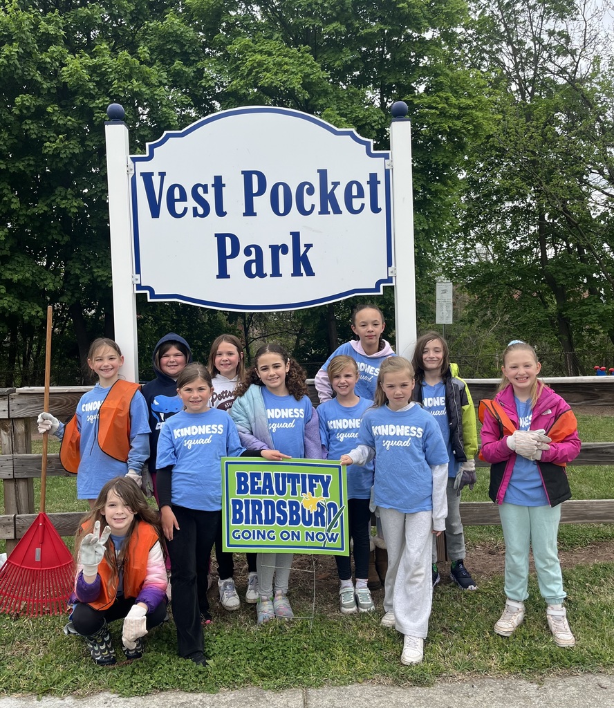 11 students standing in front of a Vest Pocket Park sign with gloves and rakes. Beautify Birdsboro Going on Now sign in front of the group.