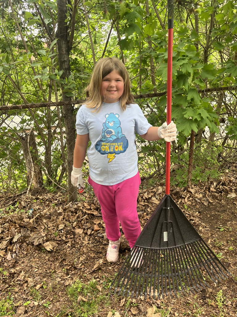 Student posing with rake