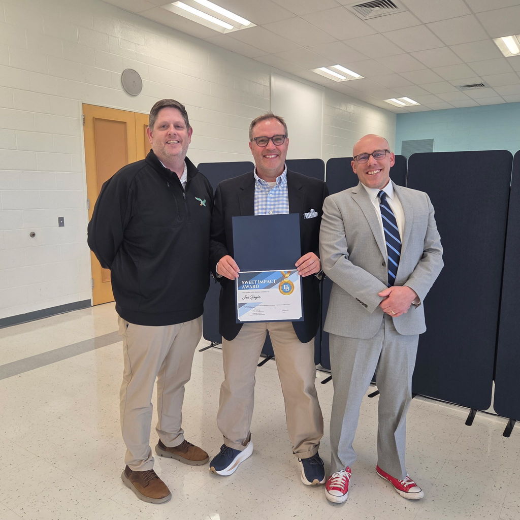 Jim Towers, Joe Boyle and Tom Voelker are standing in the Daniel Boone Board Room smiling for the camera while Joe Boyle holds his Sweet Impact Award Certificate.
