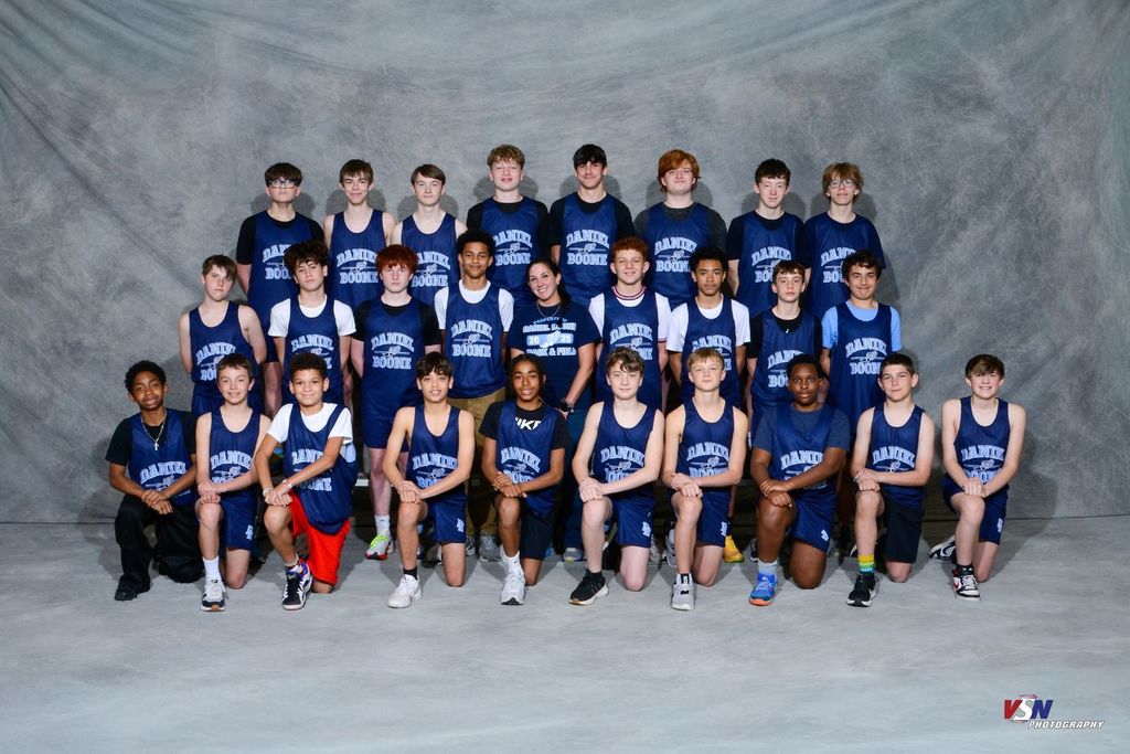 Professional photo of 27 boys wearing their Daniel Boone Track outfits in front of a grey background.