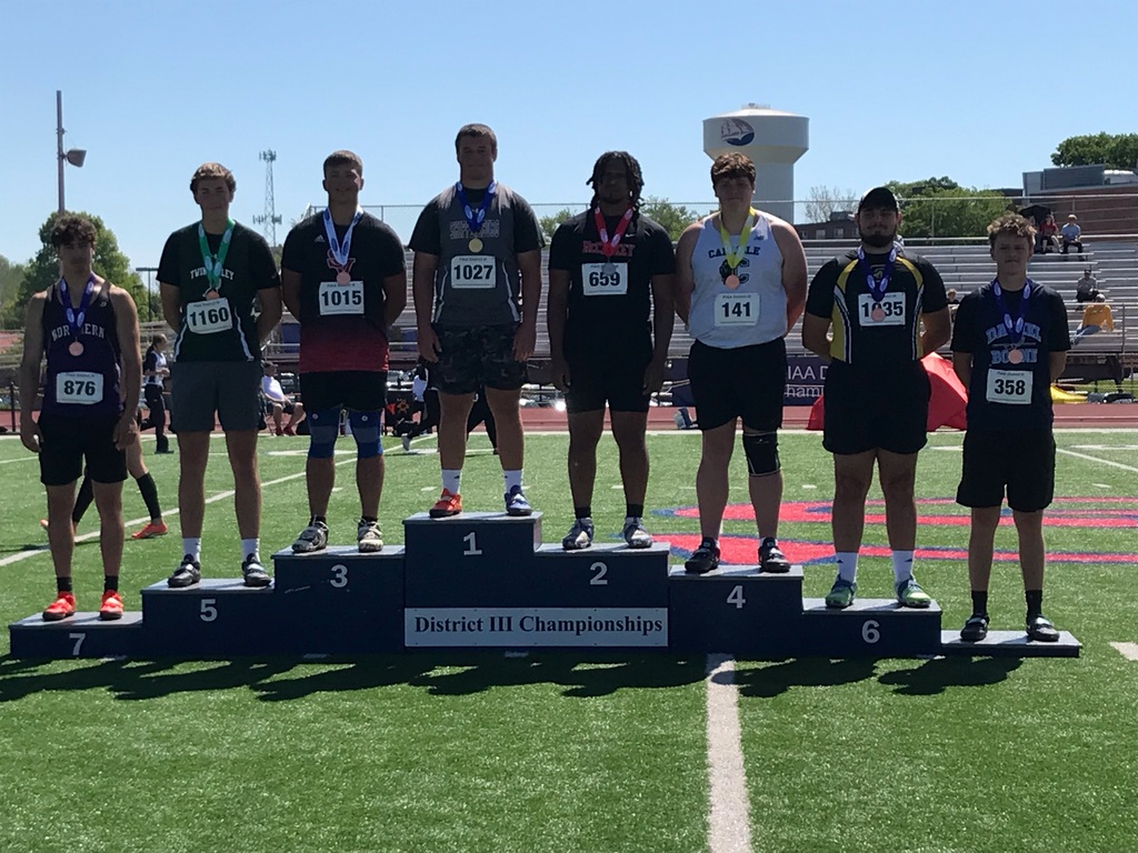 Eight students wearing number bibs and medals standing on a rising podium showing 1st - 8th place in the District III Championships