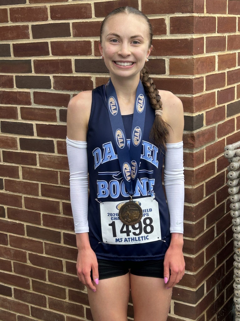 Julia Leady wearing her medal and Daniel Boone track uniform with the running bib #1498.