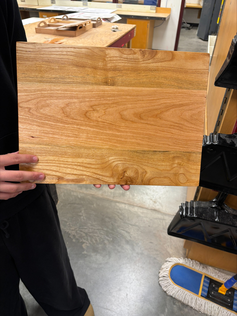 Serving board made of three different pieces of wood all stained with the same color.