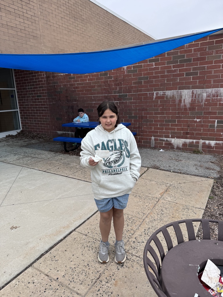 One student picking up trash from the playground.
