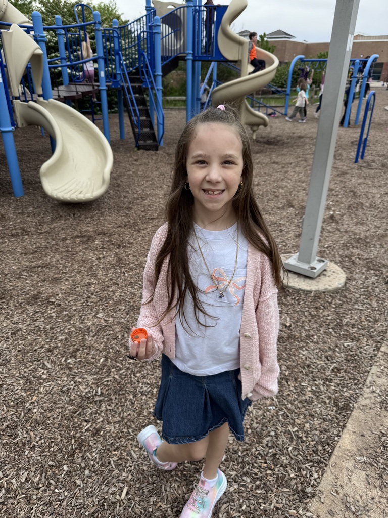 One student picking up trash from the playground.