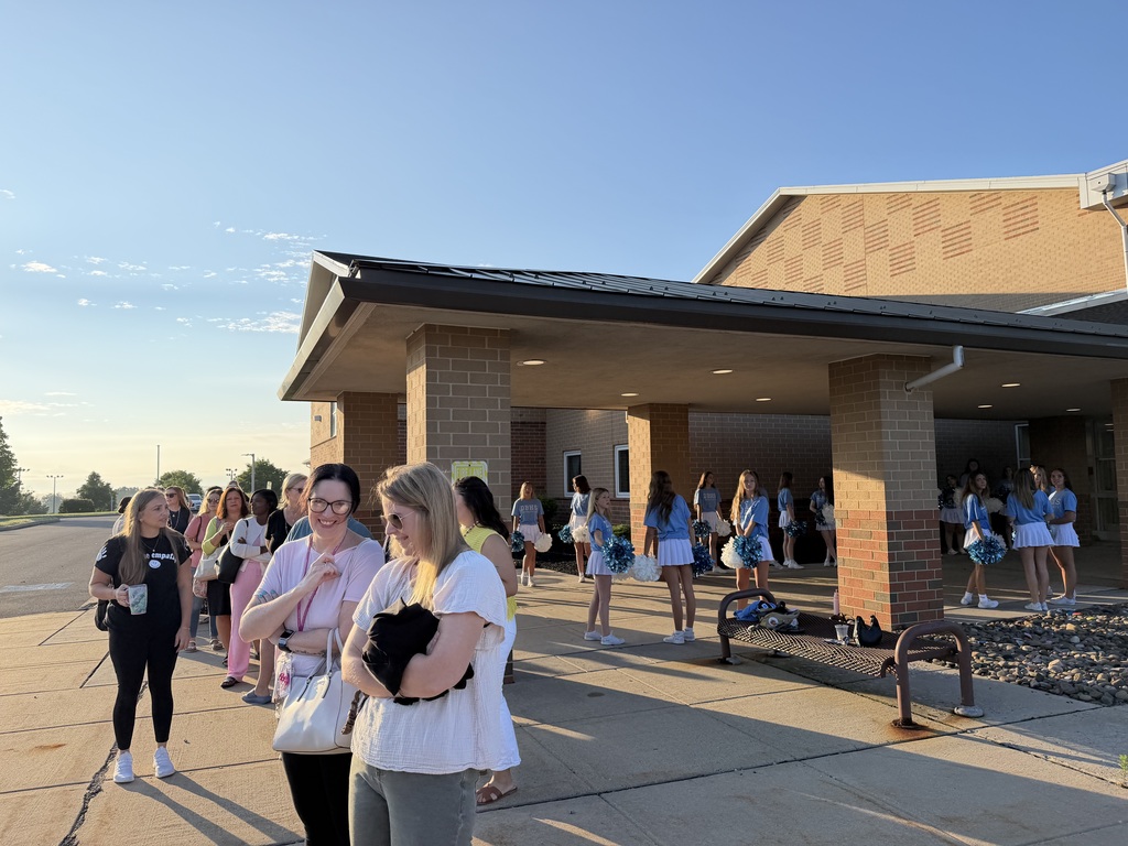Staff wait outside of the middle school in line at the Perk UP Truck.