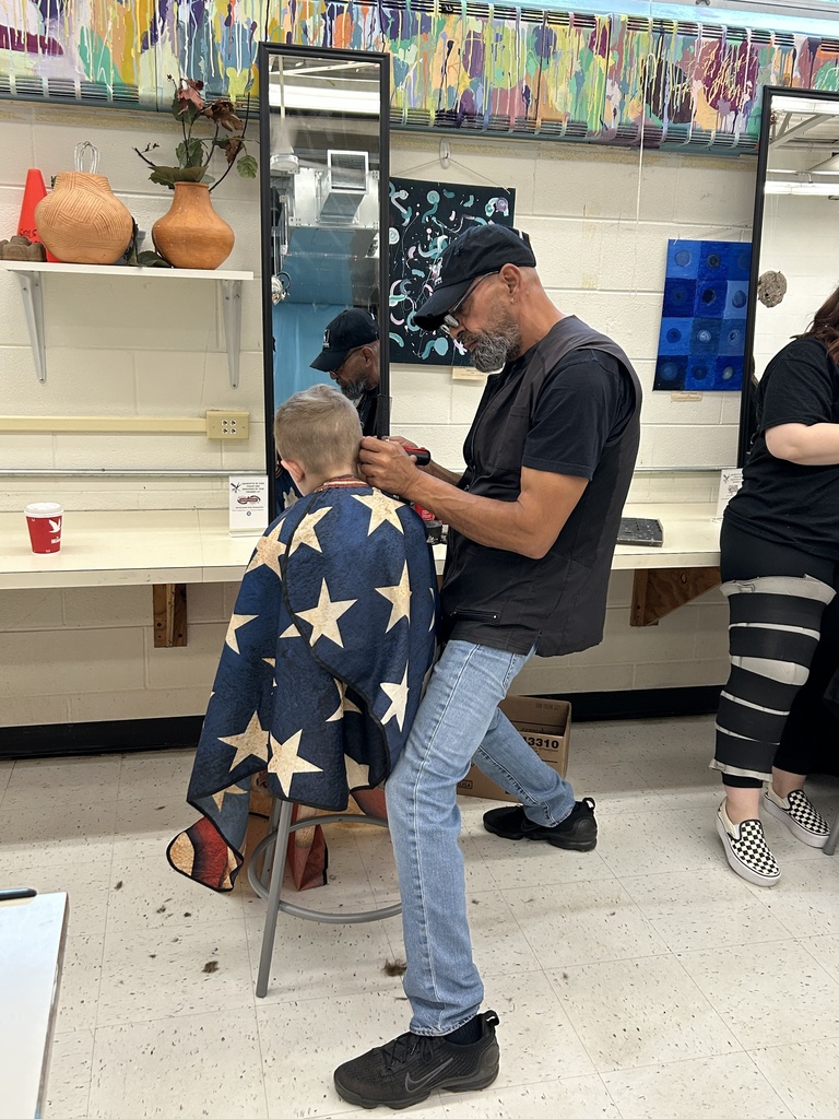 Picture of Sal's Barbershop cutting a student's hair