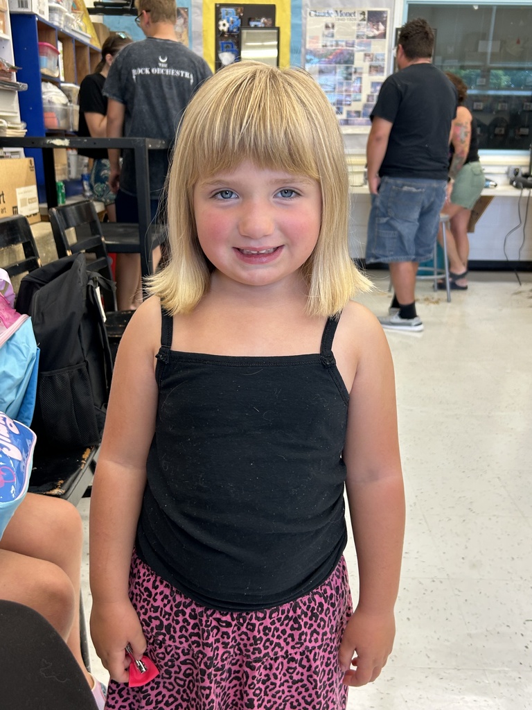 Picture of a student with a fresh haircut - young blonde girl with short haircut.