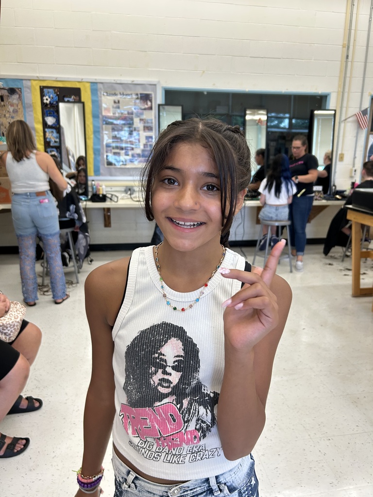Picture of a teen student with a fresh haircut and french braids.