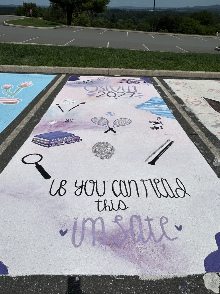A pastel purple and white parking spot is decorated with βClass of 2027β lettering and illustrations representing the studentβs interests, including tennis rackets, a fingerprint, a magnifying glass, books about forensic science and criminal justice, and other small symbols. The words βIf you can read this I'm lateβ appear across the bottom.
