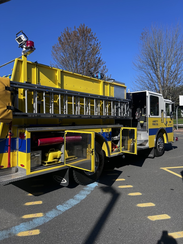 Photo of Amity Fire Company's fire truck. Yellow with blue stripe.