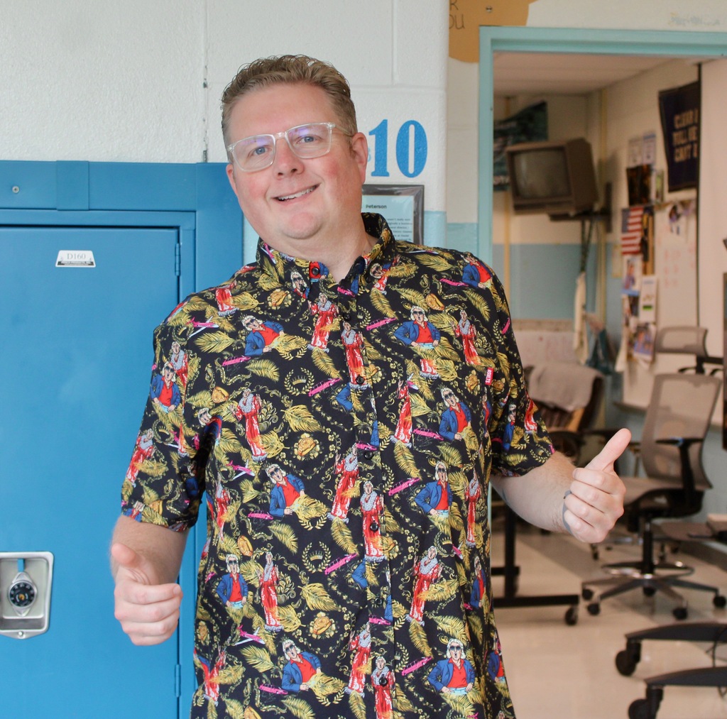 Teacher, Mr. Peterson, shows off his Hawaiian shirt and two thumbs up!