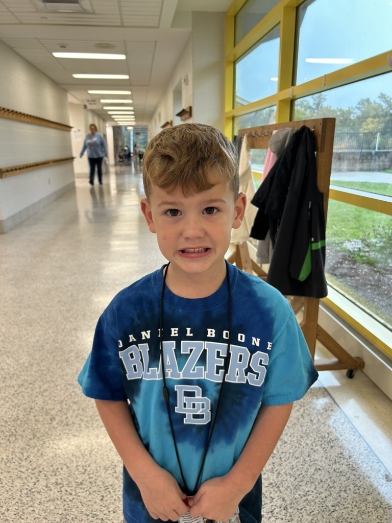 Student smiling for the camera wearing a tie-dyed Blazers t-shirt