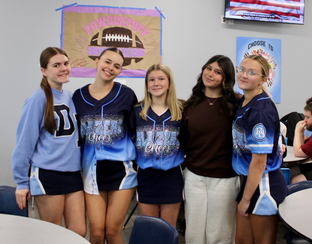 Group of 5 students three wearing Blazers Cheer jerseys, one in a blue DB sweatshirt and one wearing burgundy top and white pants